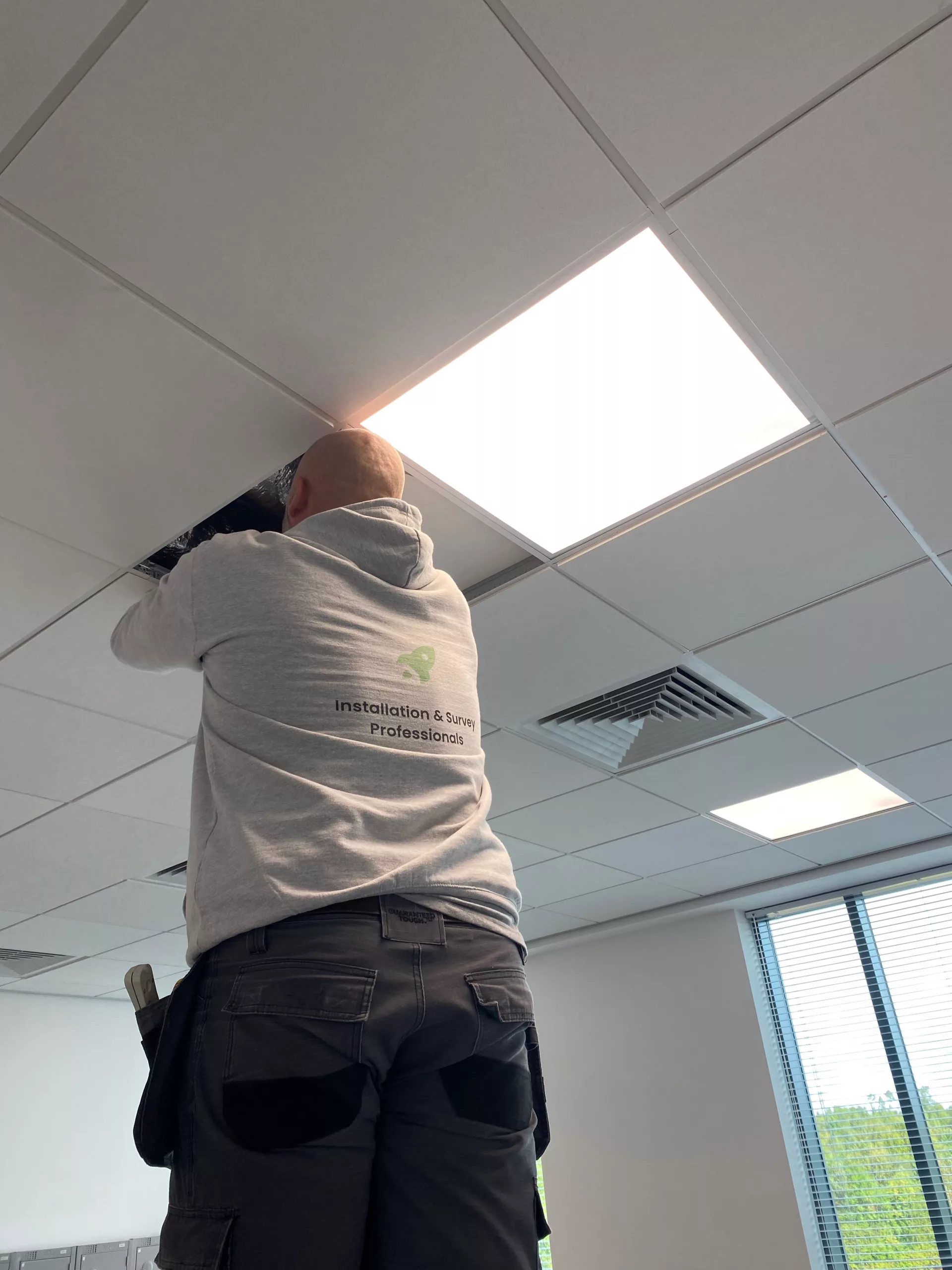 The purpose of this image is to show an example of a Wi-Fi Access Point being ceiling mounted